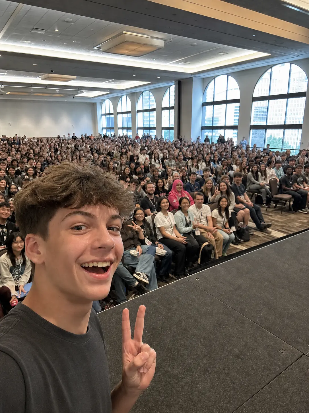 Panel Front Row. Capture a shot from inside a packed panel with the crowd behind you.