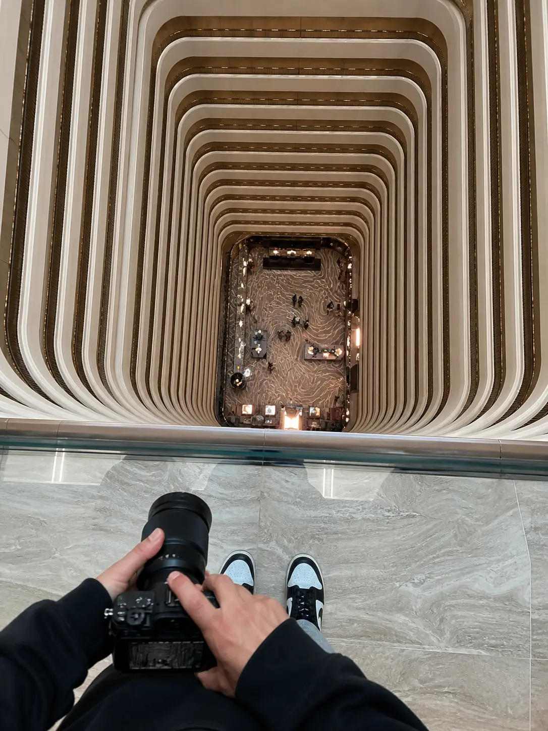 Balcony Scale Shot. Get a vertigo-inducing shot straight down a hotel atrium — never leaning or blocking.