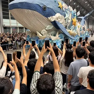 The Sea of Phones. Capture the wall of raised phones as a guest or float passes.