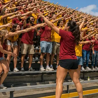Rowdiest row: Get an entire row or room of strangers doing your chant. Bright daytime scene.