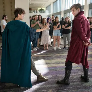 Hero vs Villain Standoff. Catch two strangers frozen in narrative tension, hero facing villain.